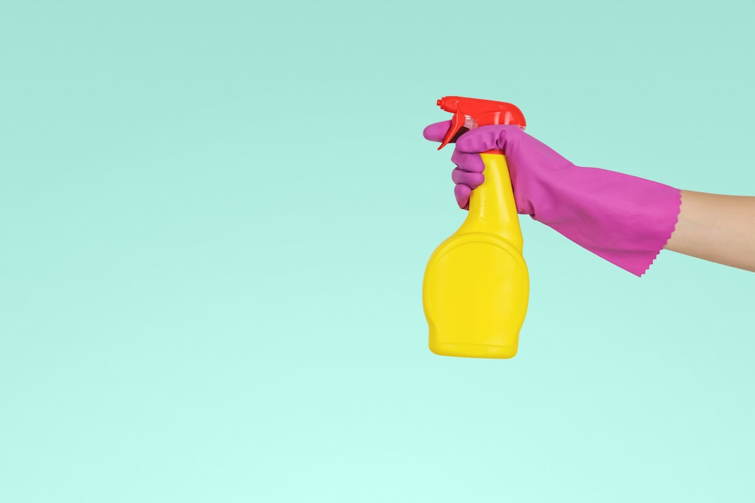 creative person-holding-yellow-plastic-spray-bottle-zmnefoi3k